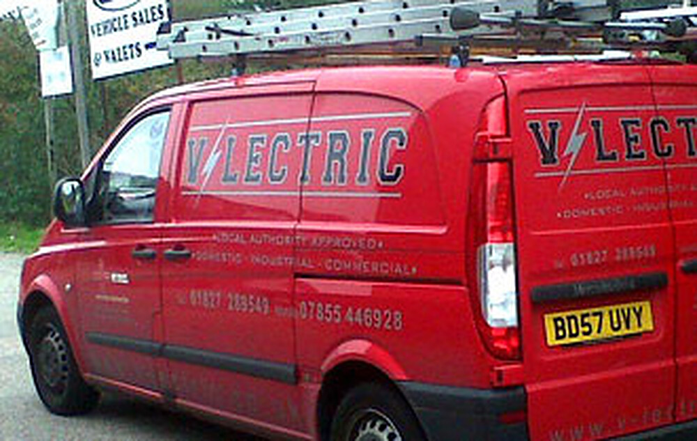 A red V-lectric Ltd van with company livery